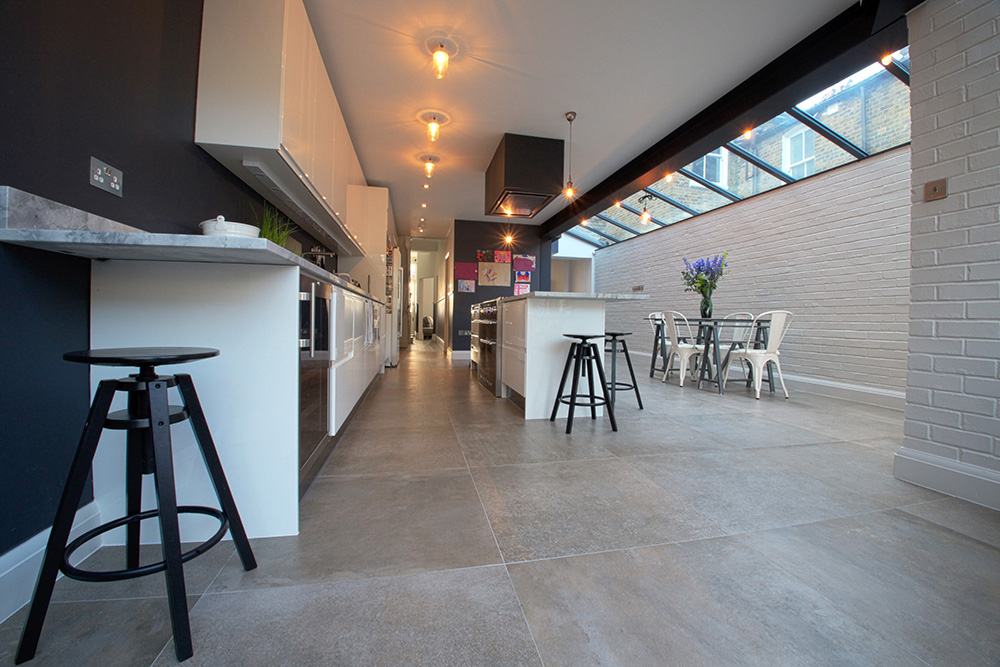 A House Extension that has created a large kitchen with a sleek breakfast bar.